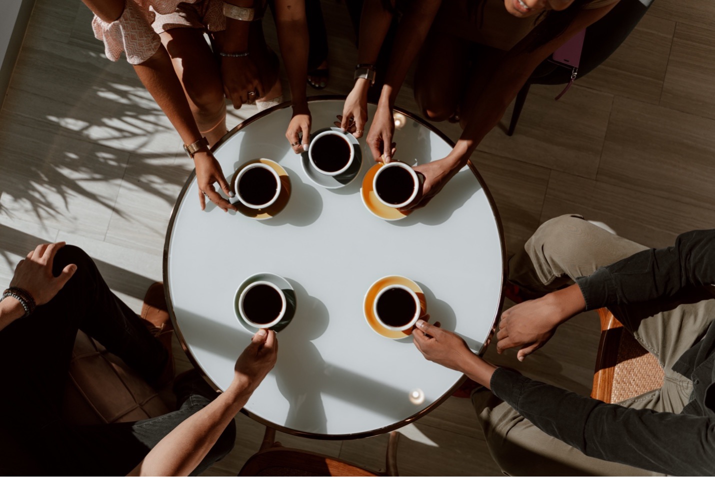 A group of people having coffee at a table