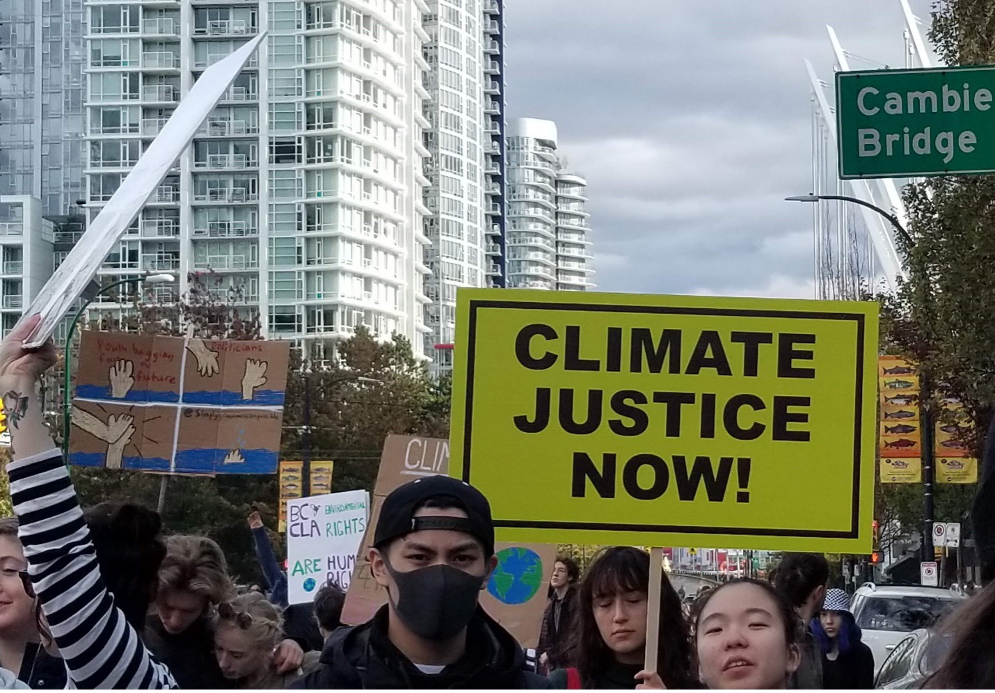 Sign says Climate Justice Now!